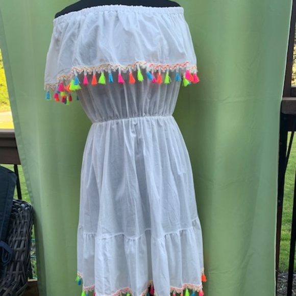 white dress with tassels on bottom